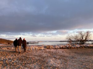 People walking under heavy clouds
