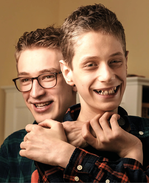 Two boys who are brothers being happy