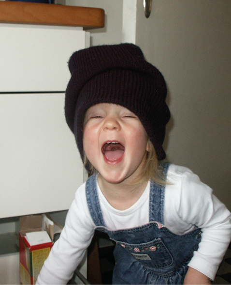 Girl with woolen hat laughing