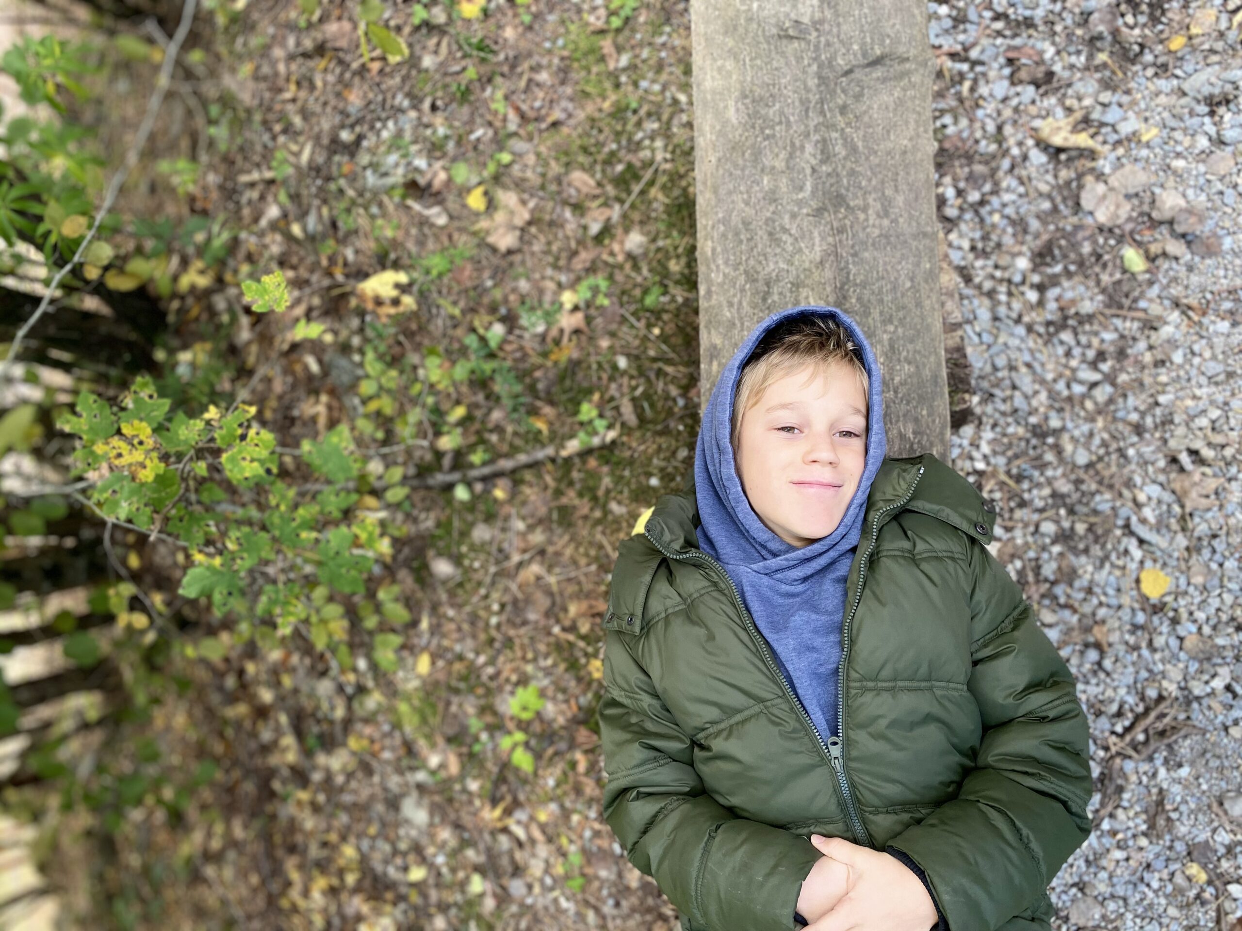Boy leaning on a tree