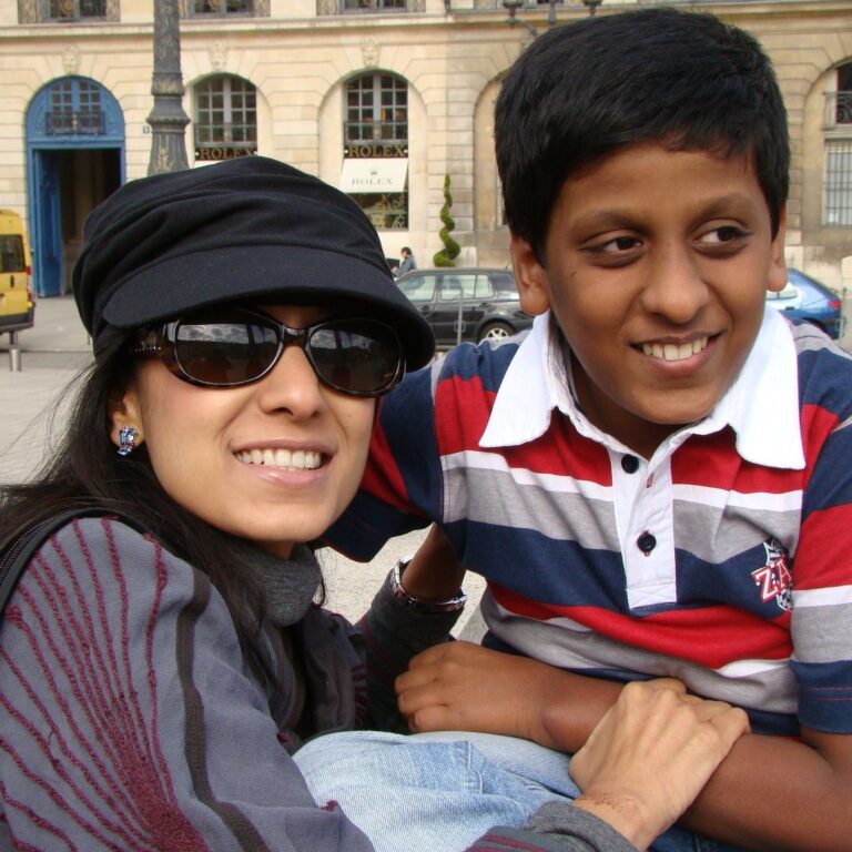 Shalini and her son smiling for the camera