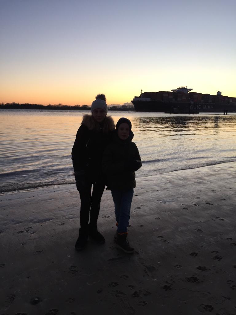 Two children in front of sunset